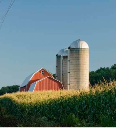 A barn next to grain silos after receiving Pole Barn Repair in Ottawa IL